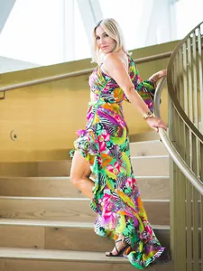 Elegant one-shoulder ruffle dress with vibrant tropical floral print for summer resort style