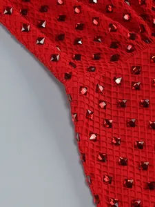 Close-up of red mesh evening dress with sparkling square rhinestone embellishments