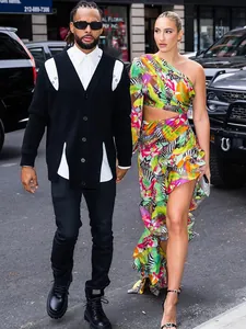 Stylish tropical print one-shoulder dress with asymmetrical ruffled hem and cutout.