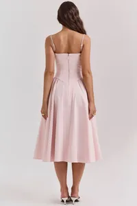Elegant pink spaghetti strap midi dress with flared skirt shown from the back view.