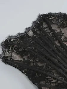 Detailed macro view of black floral lace corset with structural boning for formal dress