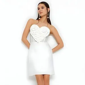 Detailed view of white strapless mini dress with large heart shaped rose design