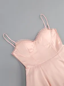 Detail shot of pink satin dress bustier with delicate lace trim