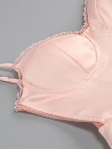 Close-up of pink satin bodice with delicate lace trim and underwire cup details.