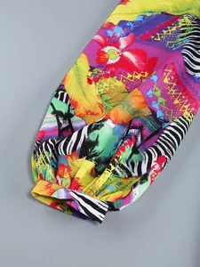 Macro detail of elasticated cuff and puffed sleeve featuring a vibrant tropical print