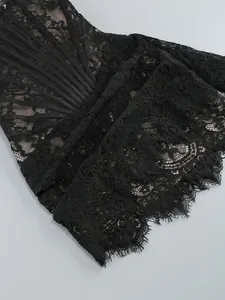 Detailed view of black lace corset dress featuring intricate floral patterns and nude lining.