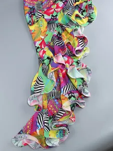 Close-up of irregular ruffles on a colorful tropical print summer dress for vacation.