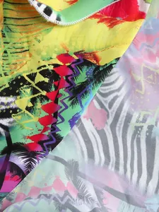 Detail of vibrant tropical palm and zebra print fabric on a summer resort dress