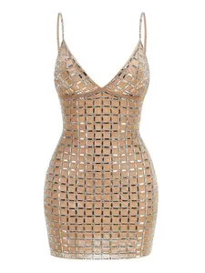Detail showing the heavy silver rhinestone grid pattern on a beige bodycon mini dress