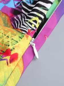 Close-up of white invisible zipper on a vibrant colorful floral print summer dress