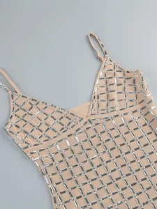 Detail view of a beige party dress featuring a heavy rhinestone grid pattern design