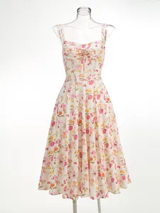Floral print midi dress with spaghetti straps and a tie-front detail on a mannequin