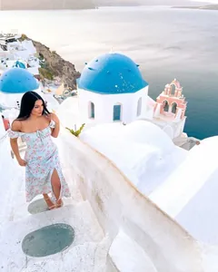 French style floral off-shoulder vacation dress with high slit shown in Santorini scenery