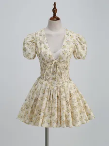 Detail shot of a deep V-neck floral mini dress with puff sleeves displayed on a mannequin.