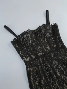 Close-up detail of high-quality intricate black floral lace on a sexy bodycon midi dress