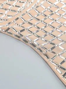 Detailed macro shot of luxury rhinestones on beige mesh fabric of an evening dress