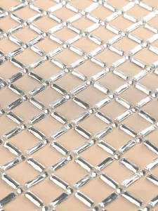 Detailed macro view of luxury heavy rhinestone and crystal patterns on mesh fabric