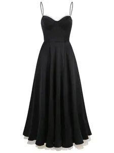 Elegant full-length view of black spaghetti strap dress with stiff mesh hem and lace trim