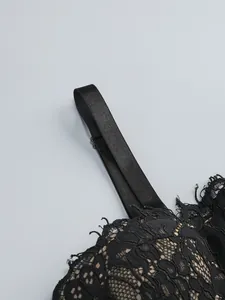 Detailed macro shot of elegant black floral lace and durable adjustable shoulder strap