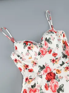 Close-up detail of white floral print dress bodice featuring lace trim and thin straps