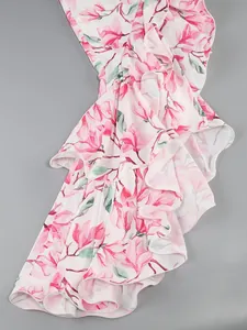 Close-up detail of multi-layered ruffles featuring a delicate pink floral print pattern