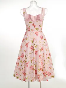 Detailed back view of a pink floral print midi dress shown on a clear mannequin