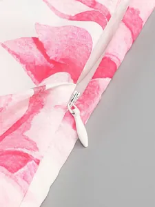 Close-up of invisible zipper on pink floral ruffled vacation dress detail