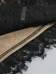 Close-up of delicate black lace and nude mesh lining on an evening dress
