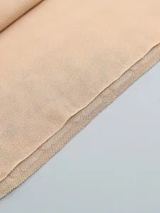 Macro detail of nude mesh fabric with sparkling hot-fix rhinestones for evening dress