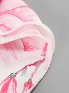 Close-up view of pink floral print dress fabric with fine ruffled edge stitching detail