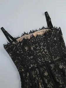 Close-up of black lace slip dress with adjustable straps and nude lining detail