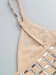 Close-up detail of heavy rhinestone embellishments on a nude beige elegant party dress