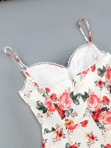 Close-up detail of white floral dress with red roses, lace trim and adjustable straps.
