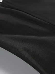 Macro view of the high-quality black hard mesh fabric texture on this elegant dress.