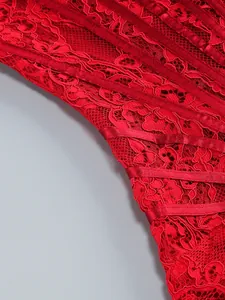 Exquisite macro detail of red lace fabric with satin ribbon stripes on evening corset dress