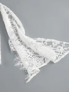 Detailed macro shot of elegant white floral lace with delicate eyelash lace trim