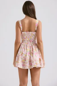 Detailed back view of a pink floral strap mini dress with pleats and a hidden zipper.