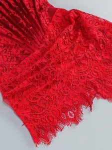 Detailed close-up view of red floral eyelash lace on a sexy corset-style evening dress