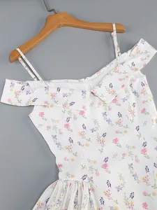 Close-up of off-the-shoulder floral dress with thin straps and ruffled neckline detail