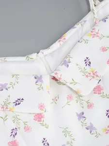 Detail view of a white floral off-shoulder dress with colorful print and zipper
