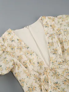 Close-up of the elegant deep V-neckline and hidden zipper on a floral summer dress