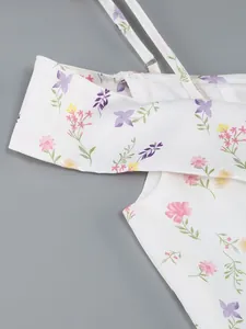 Close-up detail of white floral print off-shoulder dress with thin shoulder straps