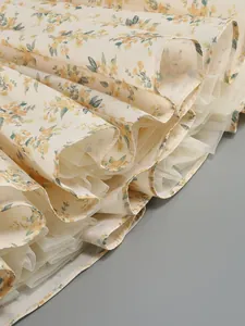 Detail view of the floral dress hem showing layers of soft white tulle for a fluffy silhouette