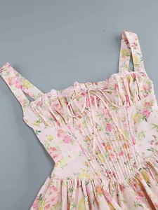 Detailed view of pink floral camisole dress bodice featuring lace trim and a cute bow