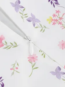 Close-up detail of invisible zipper on floral print dress fabric