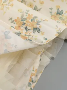 Close-up detail of floral print fabric and layered tulle lining of vacation dress
