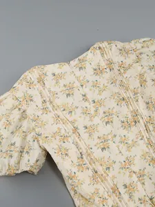 Detailed close-up of back pintuck stitching and hidden zipper on a floral dress