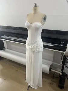 Detailed view of a white sequin strapless evening gown with an elegant ruched skirt