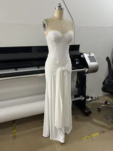 Detailed view of elegant white sequined strapless evening gown with pleated waist detail