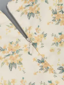 Detailed close-up showing the hidden back zipper of a yellow floral print summer dress